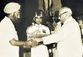 Sardar Gurdeep Singh Samra, father of Second Lieutenant Shamsher Singh Samra, receiving the Maha Vir Chakra from President V.V. Giri, that was awarded to his son, posthumously.