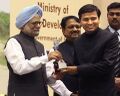 Surendra Singh IAS, receiving an award from Dr. Manmohan Singh, Prime Minister of India.