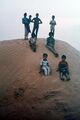 Village children enjoying sand dunes